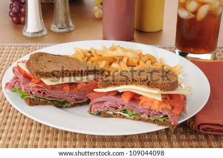 A corned beef sandwich with french fries