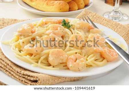 A plate of shrimp scampi with garlic butter sauce