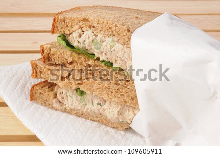 Tuna sandwich wrapped in white butcher paper