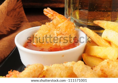 Closeup of coconut shrimp in sweet and sour sauce