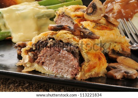 Close up of Beef Wellington with asparagus and mashed potatoes