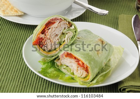 Turkey or chicken wraps with lettuce, cheese and hot pesto sauce
