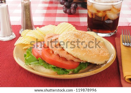 A healthy salmon burger with lettuce and tomato