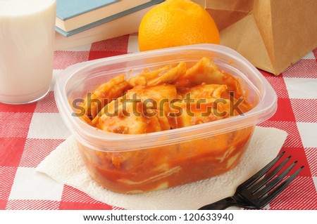 Sack lunch with leftover beef ravioli and an orange
