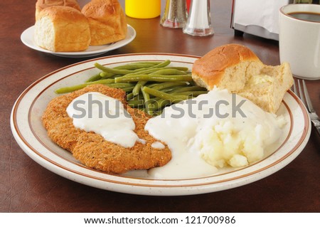 Chicken fried steak with mashed potatoes and country gravy