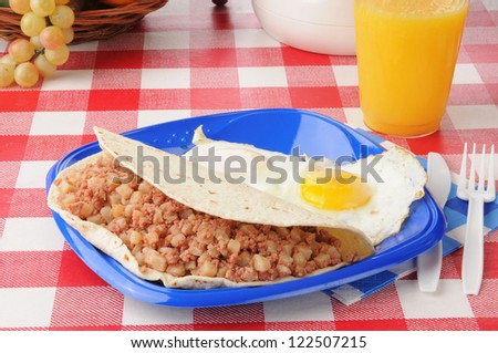 a breakfast burrito with corned beef hash and fried eggs