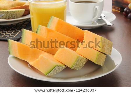 Sliced cantaloupe with coffee and orange juice