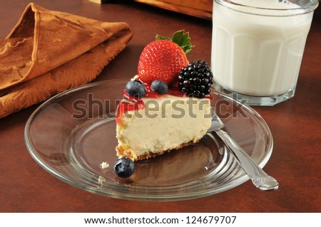 A slice of cheesecake with strawberries, blueberries and blackberries