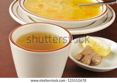 a cup of green tea with ginger, lemon and chicken noodle soup