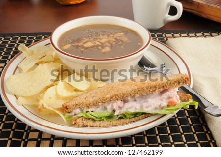 A deviled ham sandwich with onion soup and potato chips