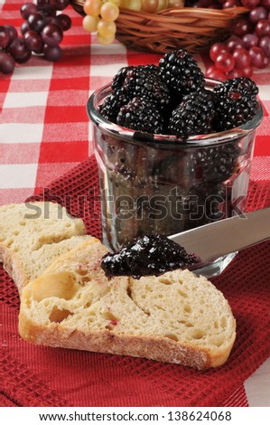 Fresh whole blackberries in a jam jar with toast