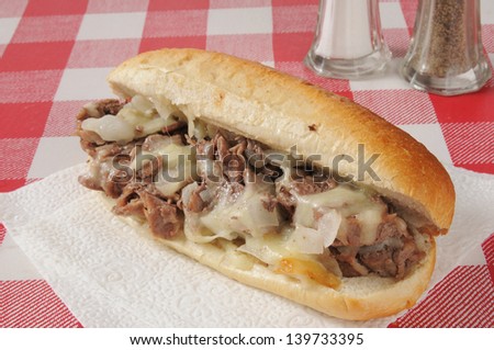 A Philly Cheese Steak Sandwich On A Picnic Table