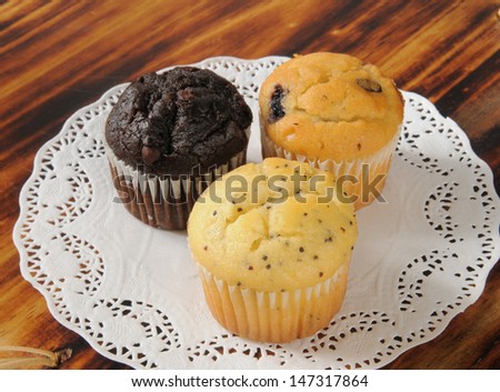 Assorted mini cupcakes on a cutting board