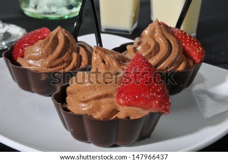 Closeup of chocolate mousse in dark chocolate dessert cups