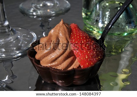 Closeup of chocolate mousse in a dark chocolate dessert cup with wine
