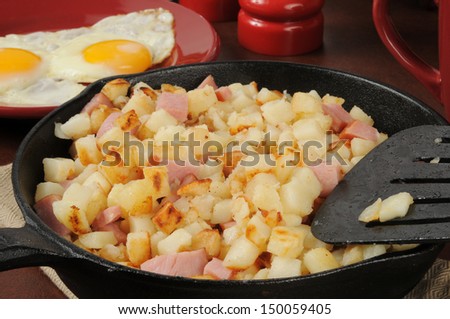 Southern style hash browns with ham and eggs in a cast iron skillet