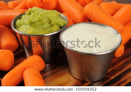 Fresh baby carrots with ranch dressing and guacomole