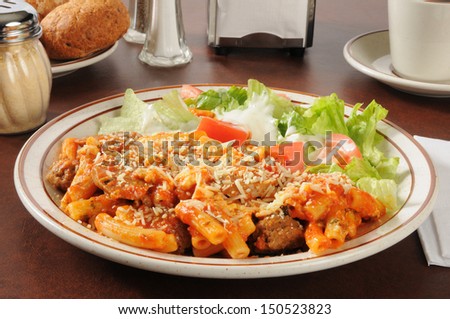 Rigatoni and sausage topped with marinara sauce and mozzarella cheese