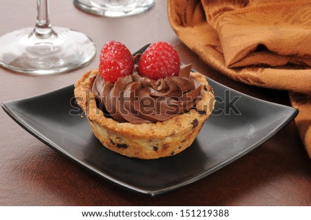A gourmet chocolate mousse dessert cup with a chocolate chip cookie crust