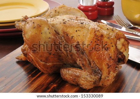 A roasted chicken on a cutting board ready to be served