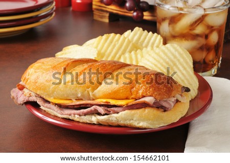A sub sandwich with roast beef, turkey, ham and american cheese