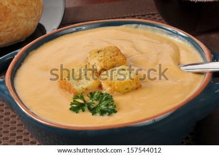A bowl of creamy lobster bisque soup with croutons