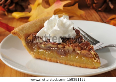 Pecan pie topped with whipped cream on a colorful holiday table