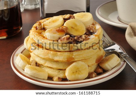 A stack of banana nut waffles with syrup in a diner