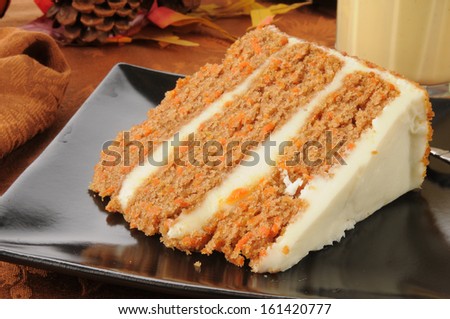A slice of gourmet carrot cake with eggnog on a holiday table
