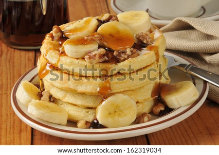 A stack of banana nut waffles with maple syrup