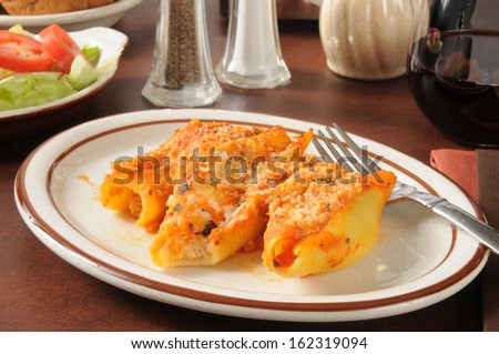 Large pasta shells stuffed with ricotta cheese and topped with marinara sauce