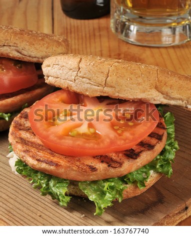 Closeup of a grilled salmon burger with beer