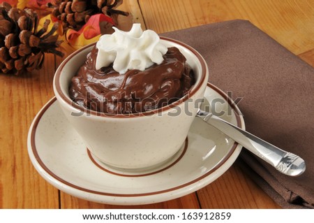 A cup of chocolate pudding with whipped cream