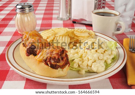 An Italian meatball sandwich with macaroni salad