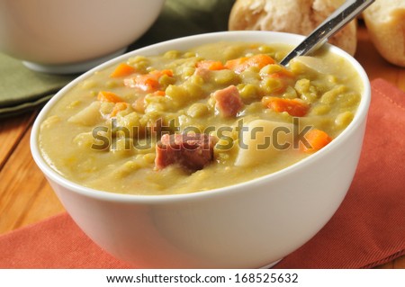 Closeup of a bowl of split pea soup with chunks of ham