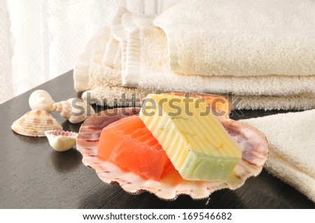 Luxury soaps infused with citrus fruits and towels near the window