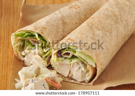 Organic chicken wrap sandwiches on brown wrapping paper