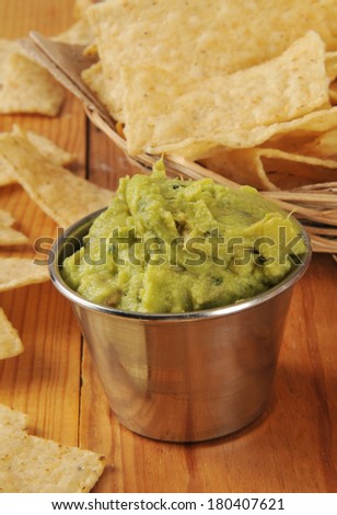 Vertical shot of guacamole dip with tortilla chips