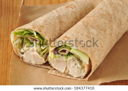 Chicken wrap sandwiches on brown butcher wrapping paper