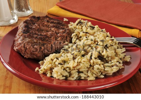 A grilled ground sirloin patty with long grain and wild rice