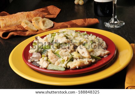 A plate of chicken risotto with portabello mushrooms and asparagus.