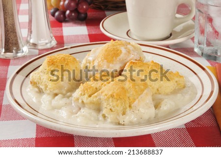 A casserole with white meat chicken, mashed potatoes and biscuits