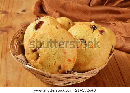 A basket of cranberry orange cookies on a rustic wooden table