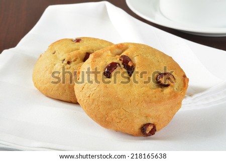 Fresh baked cranberry orange cookies on a white napkin