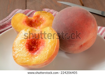 Fresh sliced organic peaches on a rustic wooden table