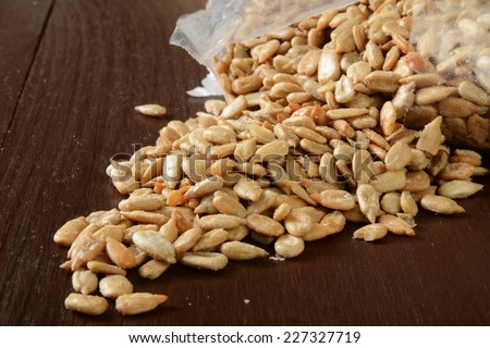 Roasted salted sunflower seeds spilling out of the bag