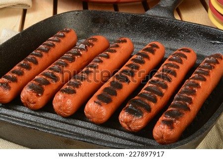 Grilled hot dogs in a cast iron skillet