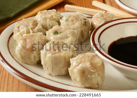 Chinese pork dumplings with soy sauce and chop sticks