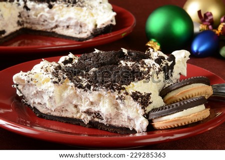a slice of cookies and cream pie on a table with Christmas decorations