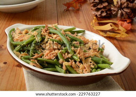 French cut green beans with crispy fried onions in a small casserole dish, a traditional holiday food